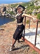 Blonde russian MILF teases by luxury legs in black nylons and high heels