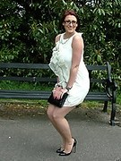 This horny MILF loves to pose outdoors in her pantyhose and high heels